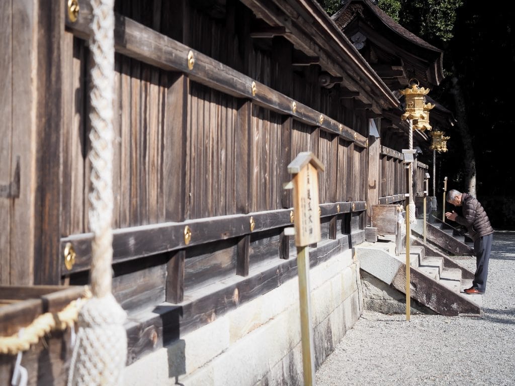 Praying in front of Kumano Hongu Taisha grand shrine, most important of the three Kumano Sanzan
