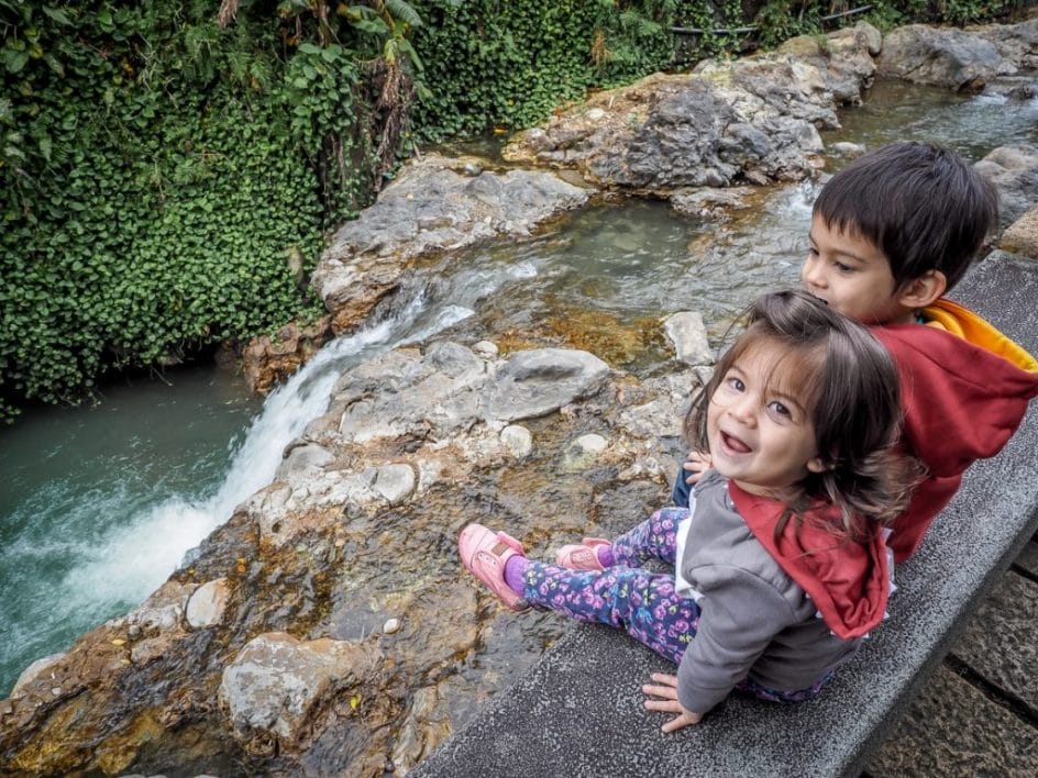Kids beside hot spring creek in Beitou hot spring park, Taipei