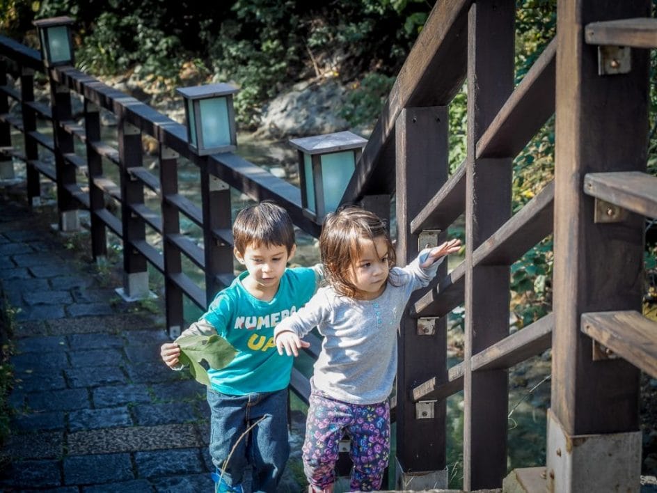 Two kids walking along a hot creek in Beitou, one of the best things to do in Taipei in December