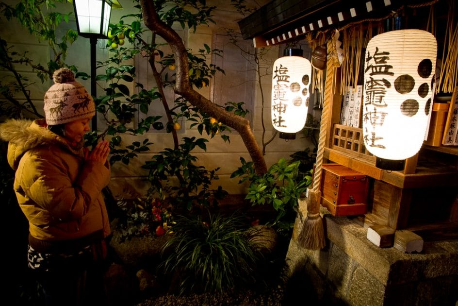 Praying at a small temple in the Teramachi Shopping Arcade, Kyoto