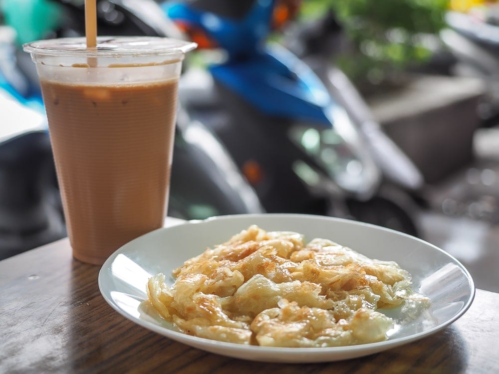 Indian paratha with sweetened condensed milk and milk tea