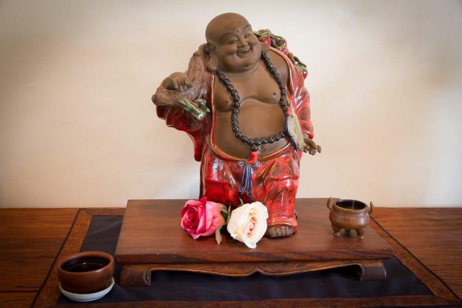 Budai, the laughing Buddha with a cup of tea