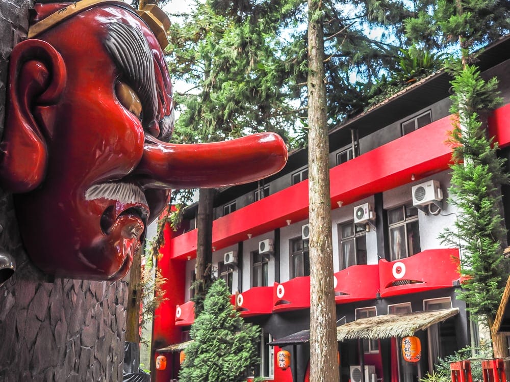 A Tengu monster watches ovetr the Monster Village Hotel