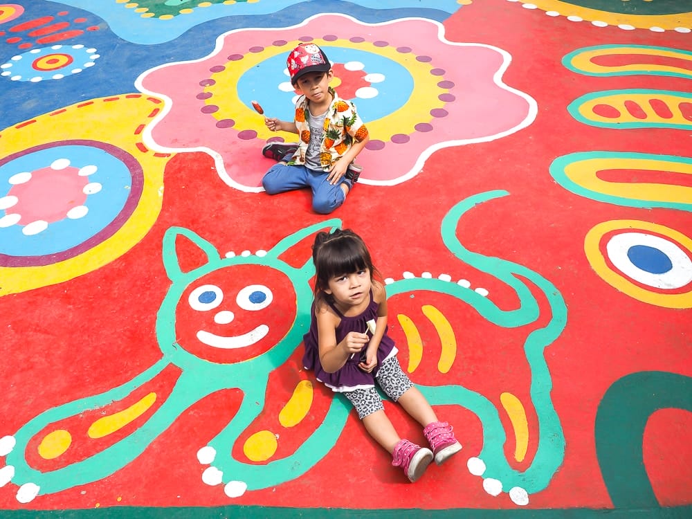 My kids on the colorfully painted floor