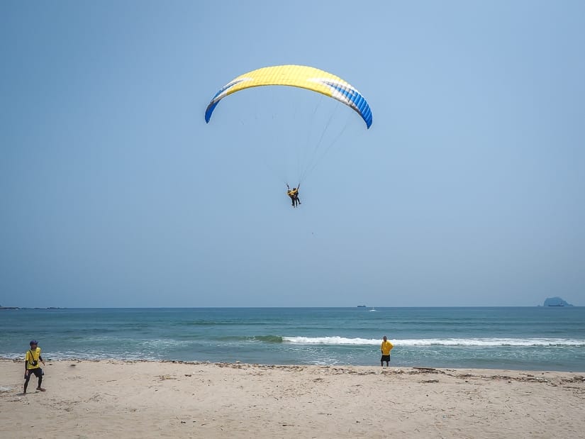 A person paragliding over Wanli beach in Taiwan in summer