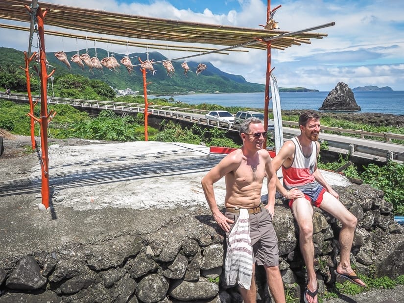 Two travelers and some flying fish hanging to dry during the Orchid Island flying fish festival.
