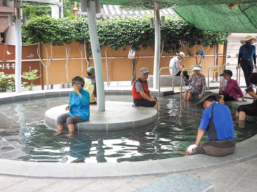 People soaking their feet at Dongnae Outdoor Foot Bath in Oncheon, Busan