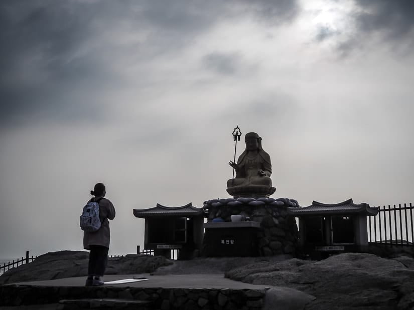 Golden statue of Jijang Bosal on the sunrise platform at Haedong Yonggungsa 