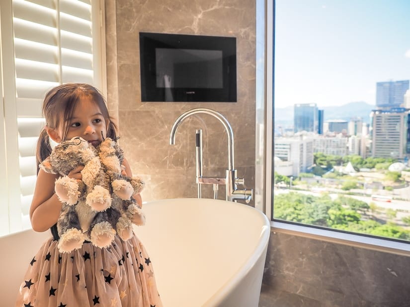 My daughter in bathroom with teddy cat in our Grand Hyatt Executive Suite