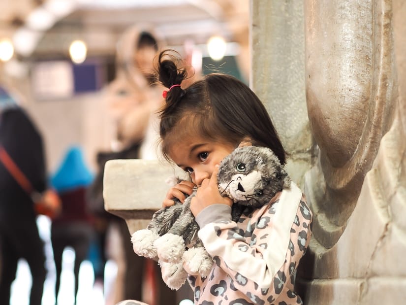 My daughter sitting against a column inside Blue Mosque