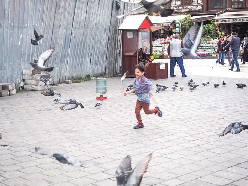 My child chasing pigeons in front of the Spice Bazaar in Istanbul