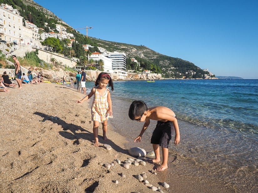 Our kids looking for rocks on Banje Beach in Dubrovnik