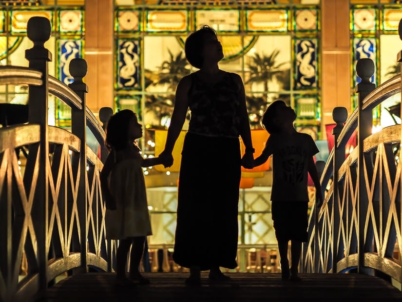 My wife and kids in front of the Grand Hyatt Muscat at night