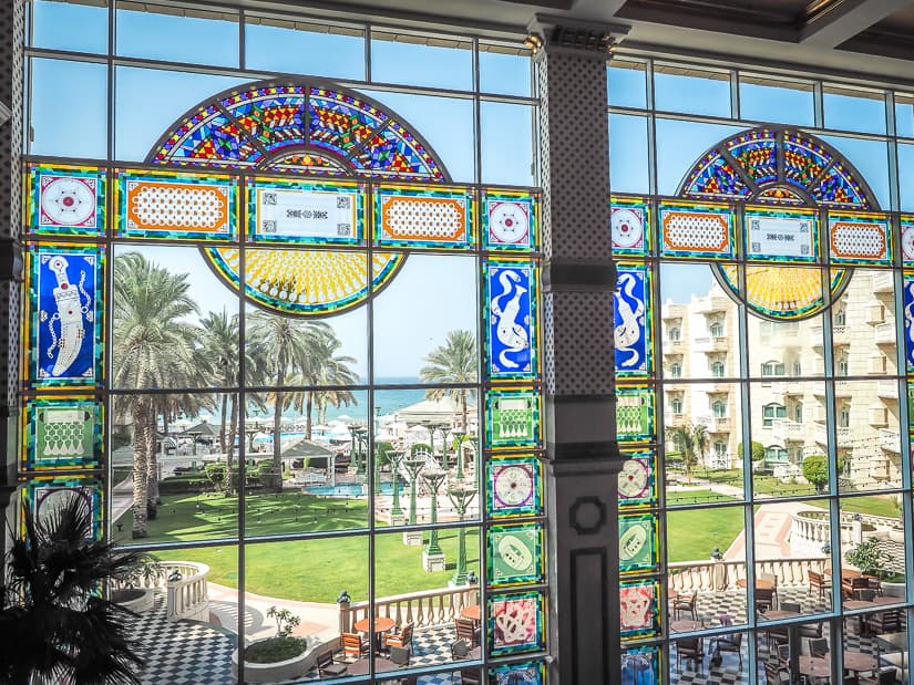 Large stained glass windows at the front end of the Grand Hyatt Muscat lobby