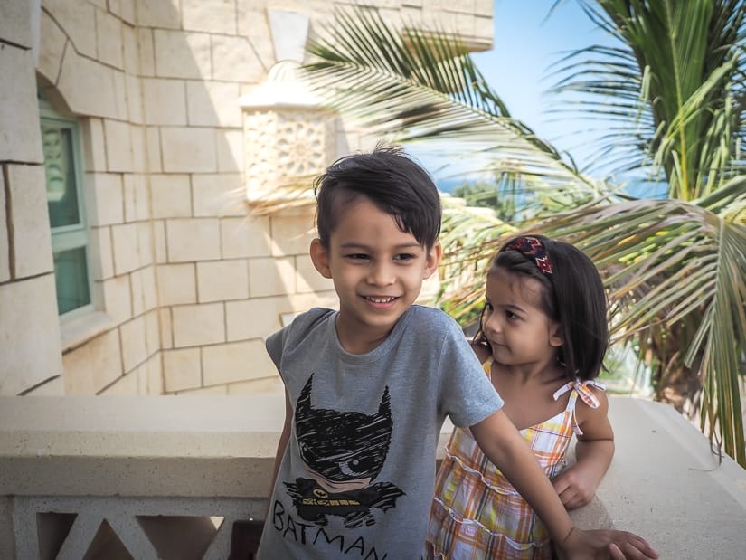 Our kids on the balcony of our Grand Hyatt king suite, with the sea in the background