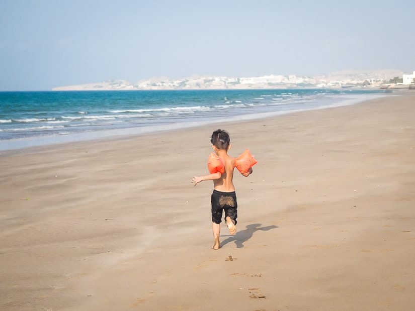 My son running on the beach in front of the Grand Hyatt