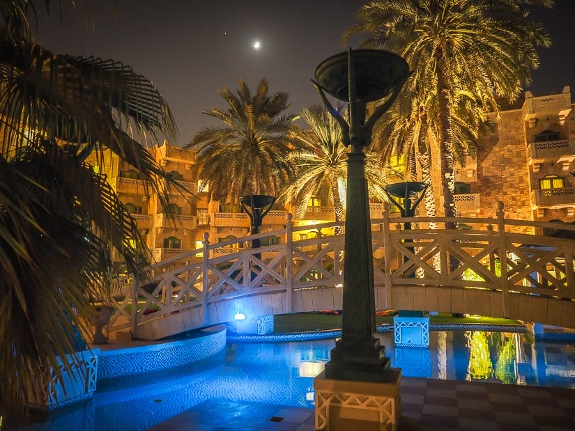 Grand Hyatt Muscat swimming pool and palm trees at night