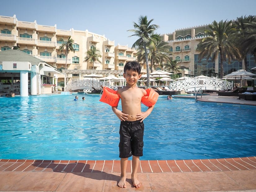 Sage in front of the swimming pool at Grand Hyatt Muscat