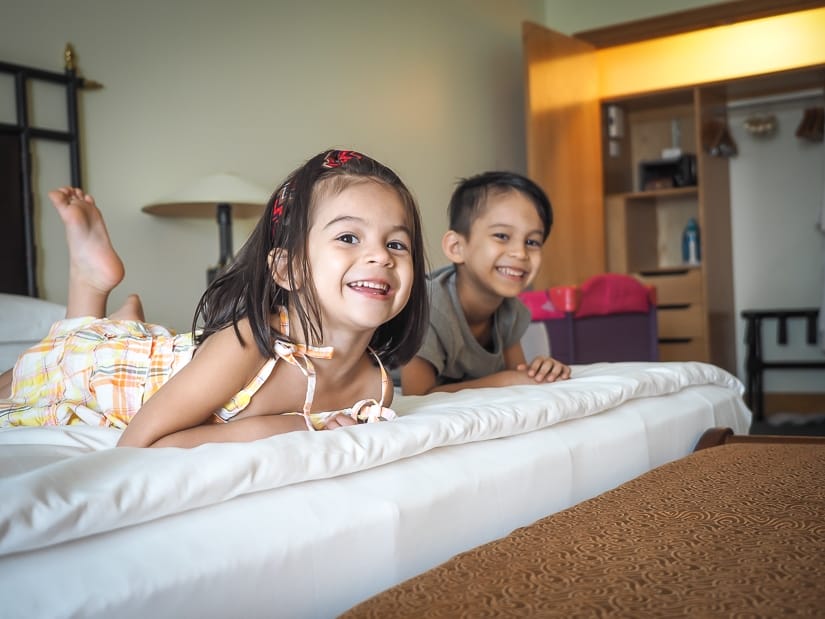 Kids laying on bed in Grand Hyatt suite