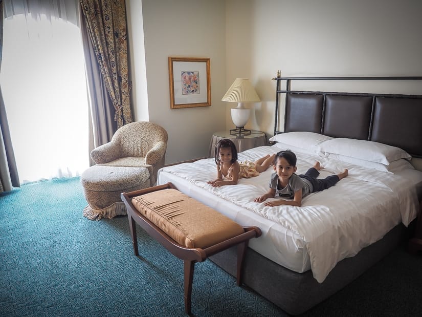 Our kids on the king size bed in grand hyatt muscat suite
