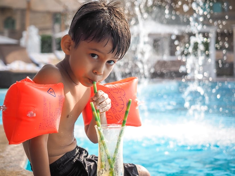 My son Sage having a mango smoothie at the Grand Hyatt Muscat poolside