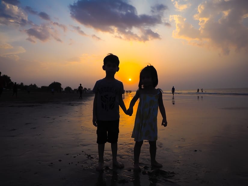 Our kids on the beach in front of the Grand Hyatt Muscat at sunset