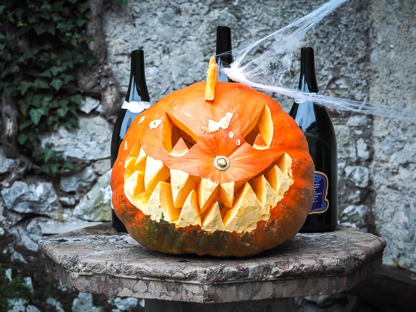 A jack-o-lantern and wine bottles at Bled Castle in October