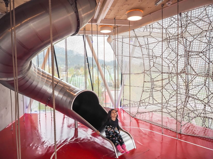 My daughter coming out of a metal slide in the Playtower at Swarovski Kristallwelten
