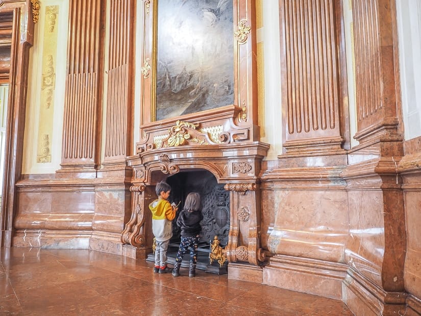 Are kids allowed in Belvedere Art Gallery? Yes! This image shows our kids in one of the many galleries, with a large fireplace and painting behind them. 