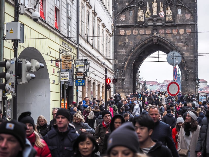 Crowds of people at the entrance of Charles Bridge in Prague