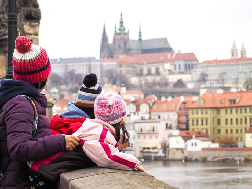 Our kids looking over the side of Charles Bridge in Prague