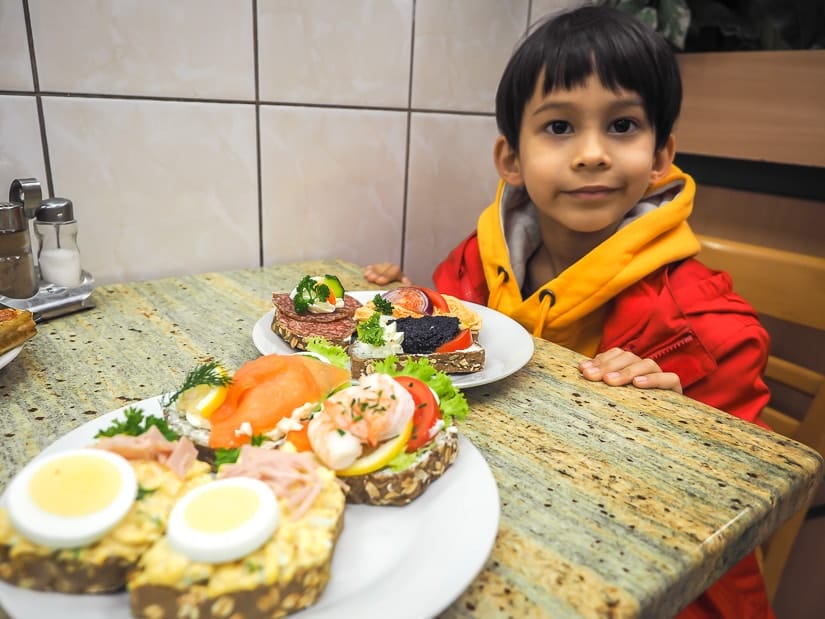 My son at a table with some sandwhiches at Open faced sandwiches at Duran Szendvics, a decent family-friendly restaurant in Budapest