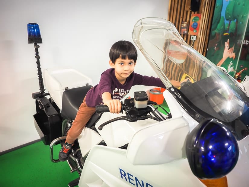 My son riding a police motorcycle at Minipolisz, the best play center for kids in Budapest