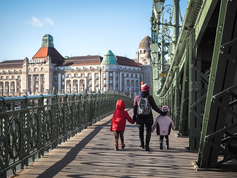 My wife walking with our kids across Liberty Bridge toward Gellert Spa in Budapest