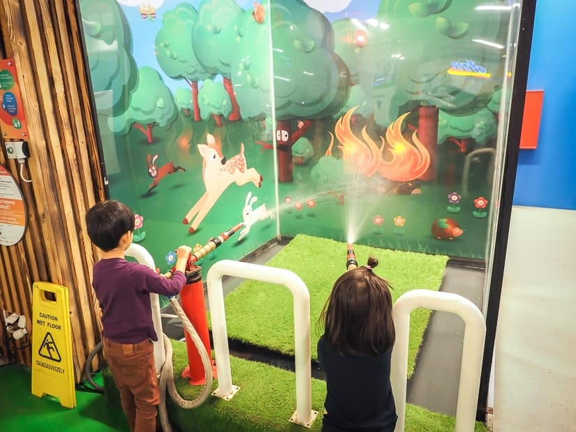 Our kids putting out a pretend fire at Minipolisz Budapest