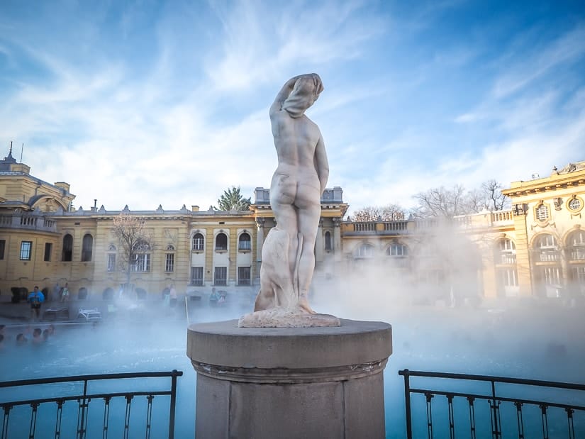 A nude statue looking over Szechenyi Baths in Budapest, which we visited with kids