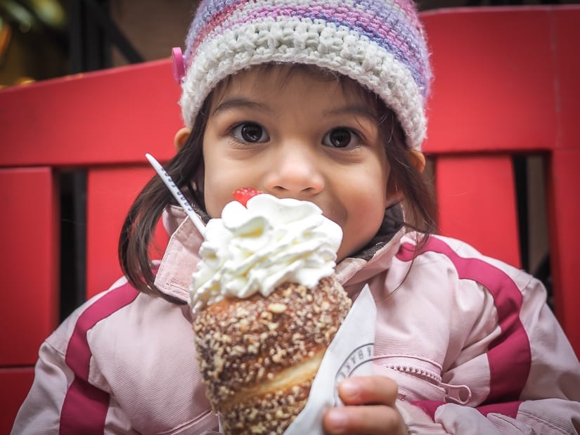 My daughter with Prague's most famous treat: trdelnik, or "tunnel cake"