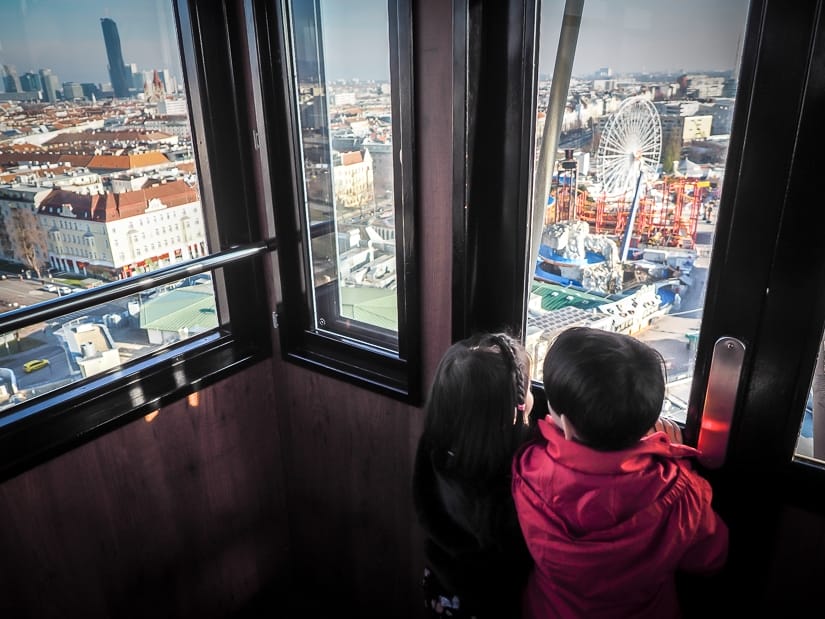 Our kids looking out from the Vienna Ferris wheel (Wiener Riesenrad), one of the best things to do with kids in Vienna