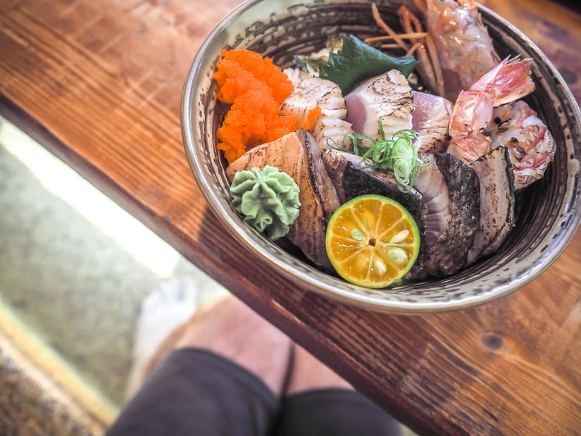 Soaking my feet in hot spring water while I eat Japanese hot spring food in Jiaoxi, one of the best places to eat in Jiaoxi