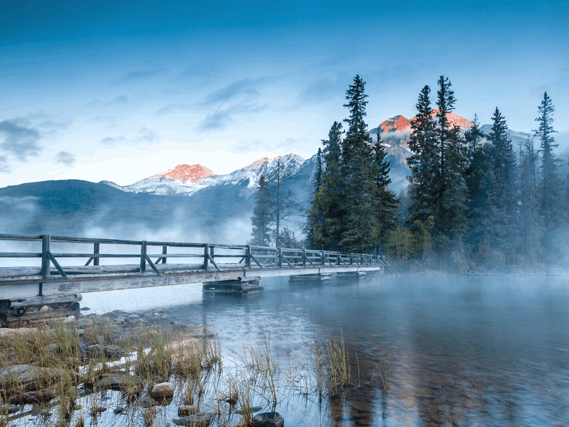 Wooden walkway to Pyramid Lake, Jasper National Park, Canada, in the early morning with mist