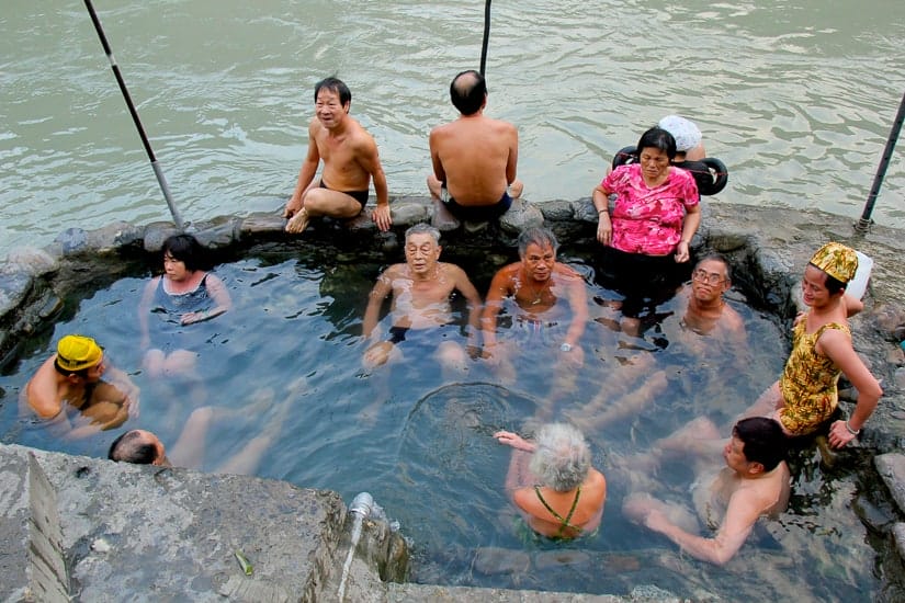 Taiwanese people in a stone pool of Wulai Hot Spring at the side of Nanshi River in Wulai Taiwan