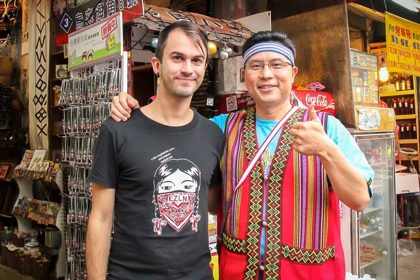 Me standing with a Taiwanese vendor on Wulai Old Street who is dressed like an aboriginal but not really one.