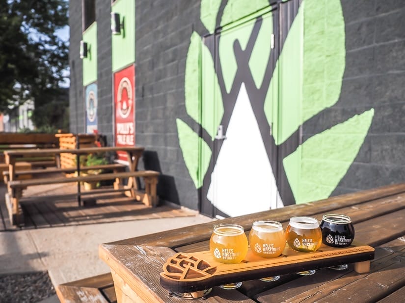 Flight of beers on picnic table in the outdoor patio at Hell's Basement, the best brewery in Medicine Hat