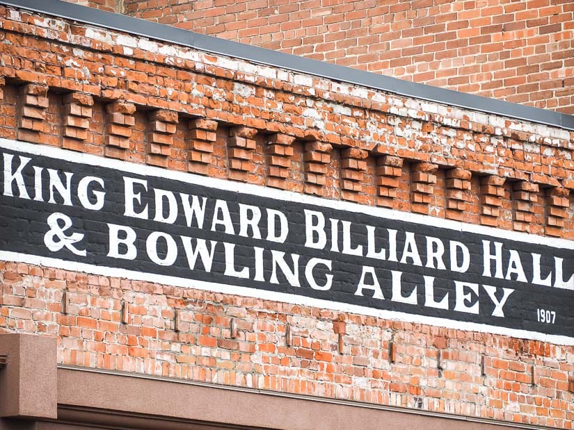 Original sign on a brick store front of King Edward Billiard Hall & Bowling Alley, dating to 1907.