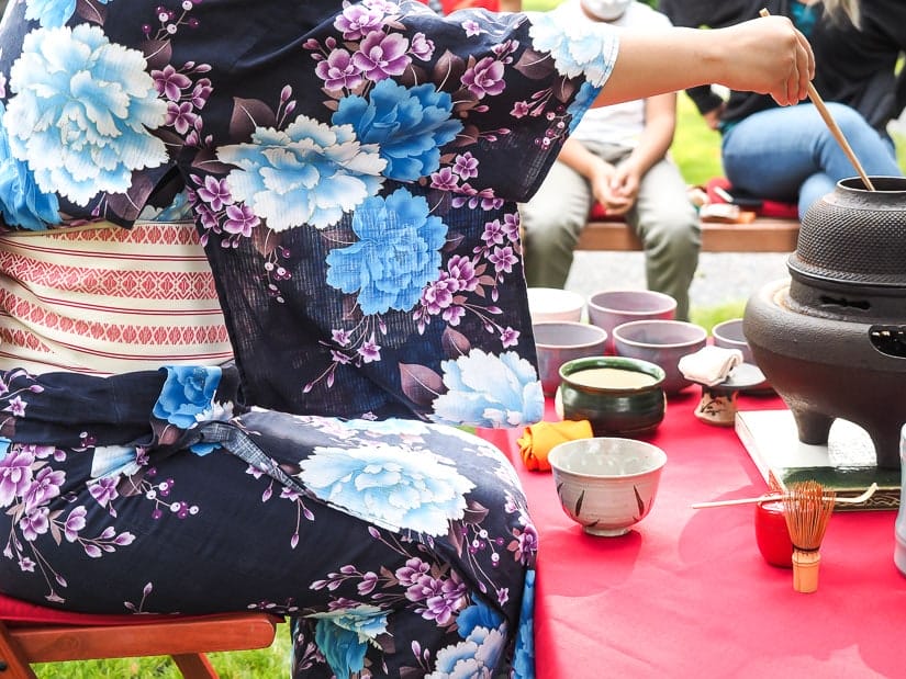 A woman performing Japanese tea ceremony at Nikka Yuko in Lethbridge
