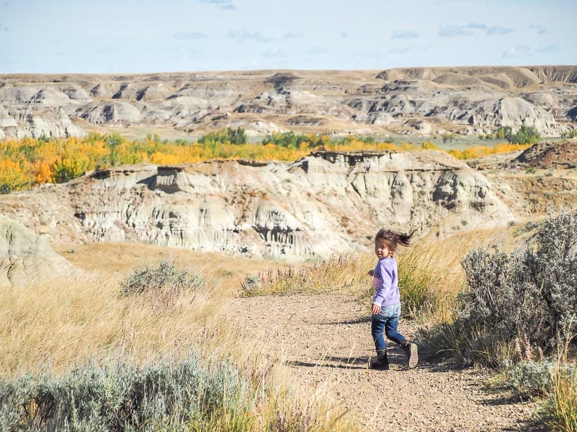 A girl running in the badlands of Dinosaur Park