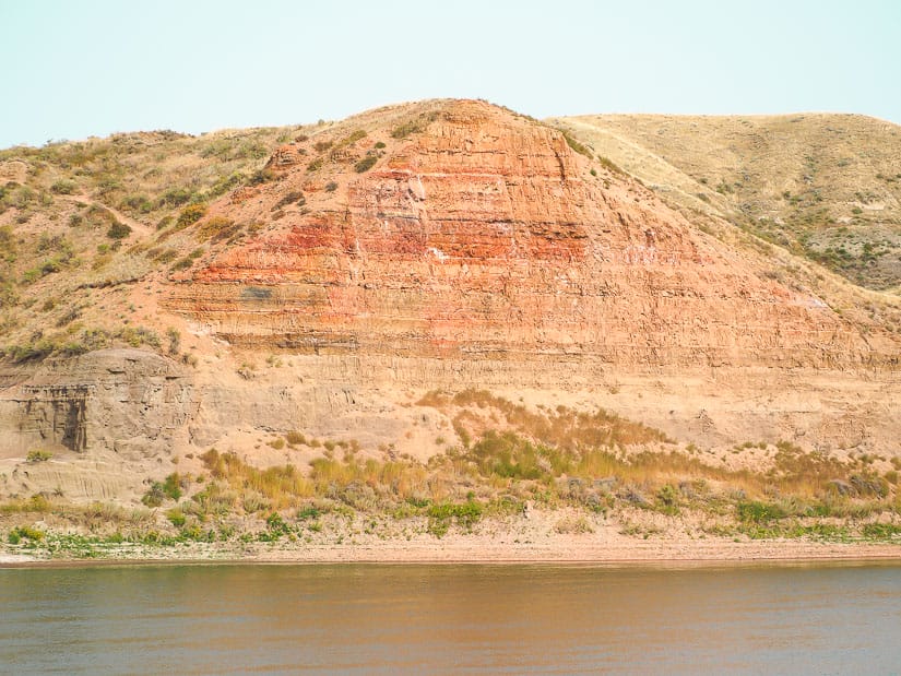 Red cliff towering above a river at Echo Dale Regional Park
