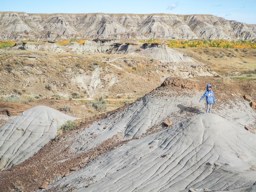 A boy on top of a hill in the badlands