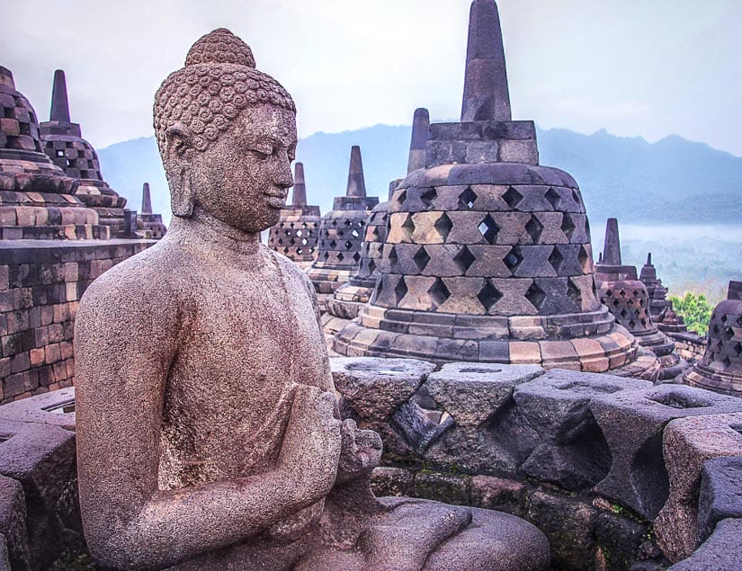 Buddha statue at the top of Borobodur, one of the most fascinating temples in Southeast Asia