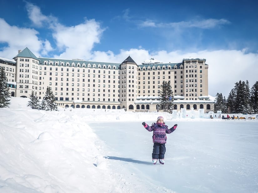 My daughter ice skating in winter in Banff, with Fairmont Chatear Lake Louise in the background